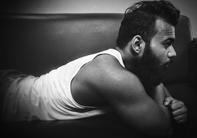 Bearded young man relaxing on sofa at home