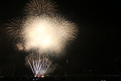 Low angle view of firework display at night