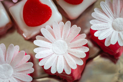 Close-up of colorful petit fours with flower decoration