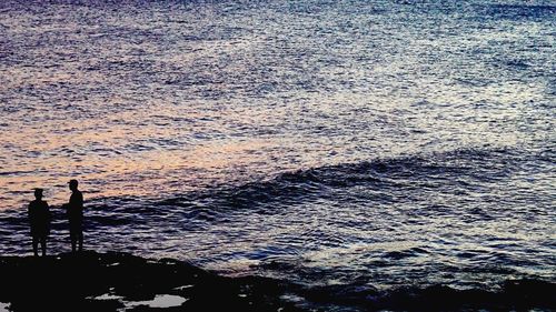 High angle view of silhouette beach against sky during sunset