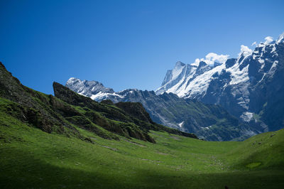 Scenic view of mountains against clear blue sky