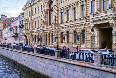 Buildings by canal in city