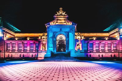 Statue of illuminated building at night