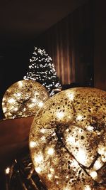 Close-up of illuminated lamp on table at home