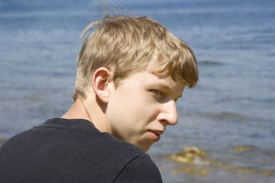 Close-up portrait of man against sky