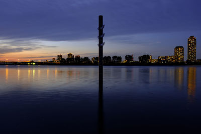 Scenic view of illuminated city against sky during sunset