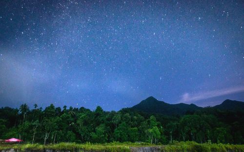 Scenic view of mountains against sky at night