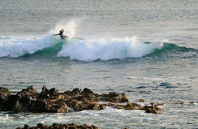 Full length of man surfing in sea