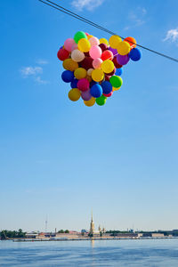 Many balloons against the background of the peter and paul fortress in st. petersburg.