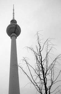 Low angle view of communications tower against sky