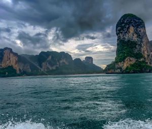 Scenic view of sea and mountains against sky