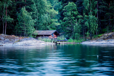 Hut amidst river and trees