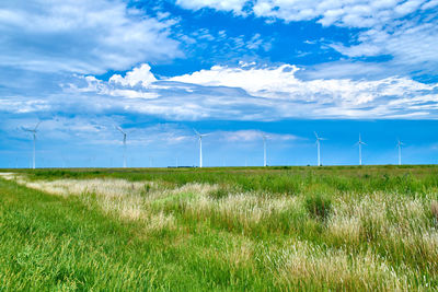 Scenic view of field against cloudy sky