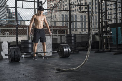 Man training at rooftop gym in bangkok