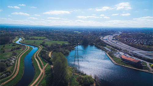 High angle view of river amidst city against sky