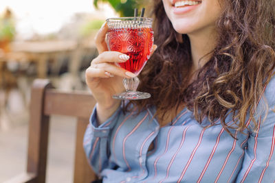 Midsection of woman holding drink