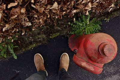 Low section of man standing by fire hydrant