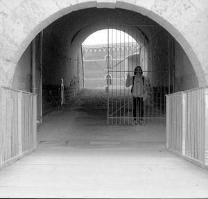 Rear view of woman walking in corridor of building