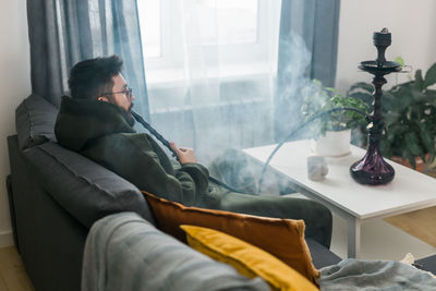 Low section of man relaxing in car