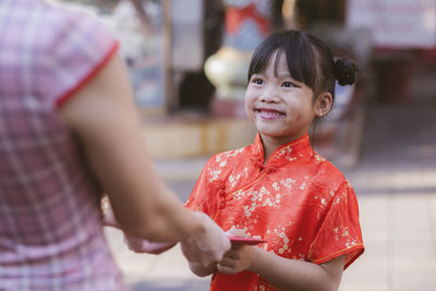 Smiling girl standing outdoors