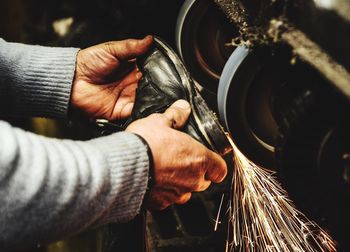 Close-up of man working on metal