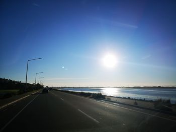 Road by sea against sky