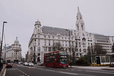 View of city street and buildings against sky