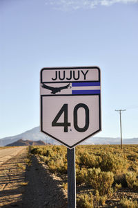 Low angle view of road sign against sky