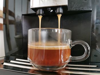 Close-up of coffee cups in glass