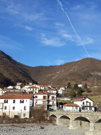 Houses in town against blue sky