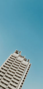 Low angle view of building against clear blue sky