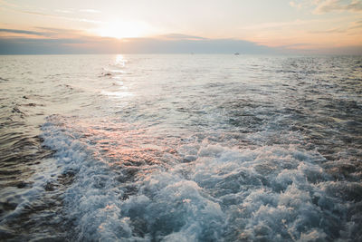 Beautiful sunset on the sea with waves from the yacht