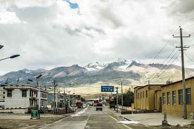 Houses against cloudy sky