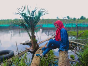 Portrait of woman standing by plants