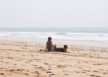 Woman with dog on beach