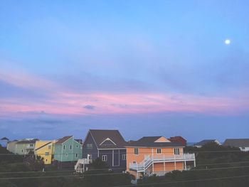 Built structures against blue sky and clouds