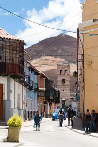 People walking on built structure against sky