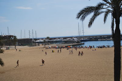 People at beach against sky