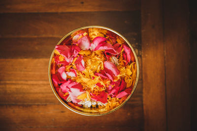 High angle view of pink flowers in bowl on table