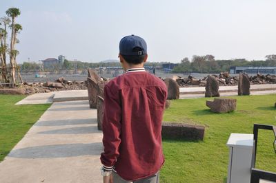 Rear view of man standing against sky