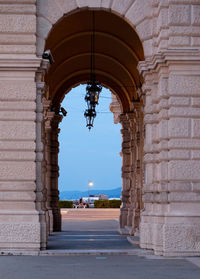 Triumphal arch against sky at dusk