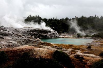 Scenic view of waterfall against sky