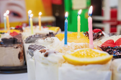 Fresh milk cakes and beautifully decorated fruits with birthday candles prepared to surprise.