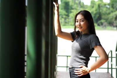 Portrait of smiling young woman standing outdoors