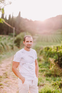 Portrait of man standing on field