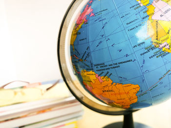 Countries and continents with colorful map on globe with books in the background. education concept.