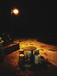 Illuminated tea light against sky at night