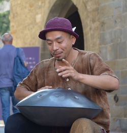Mid adult man sitting outdoors