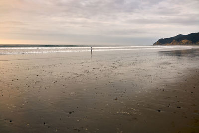 Scenic view of beach against sky during sunset