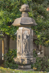 Stone sculpture against historic building